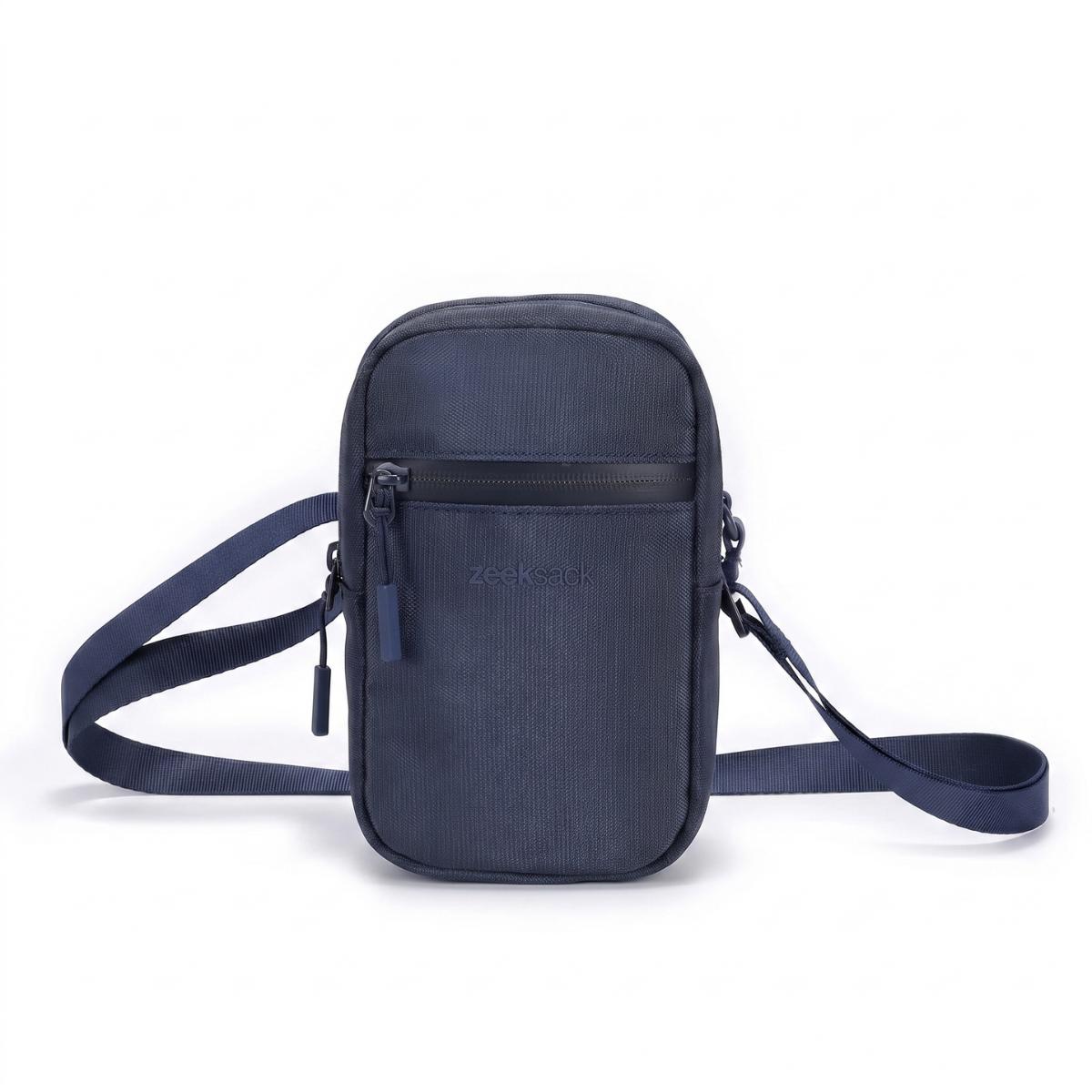 Zeeksack Travel Pouch (mørkeblå) – skulderrem og frontlomme med glidelås.