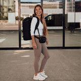 Zeeksack - Kvinne med The Organizer 30L på ryggen og en Crossbody Organizer rundt livet.